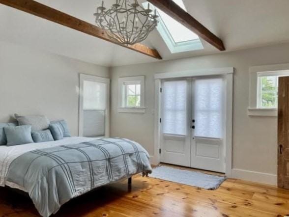 8 S St, Dennis, MA 02639 - bedroom featuring a chandelier, a skylight, wood finished floors, baseboards, and french doors
