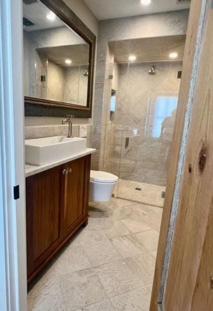 8 S St, Dennis, MA 02639 - full bathroom with a shower stall, vanity, toilet, and recessed lighting