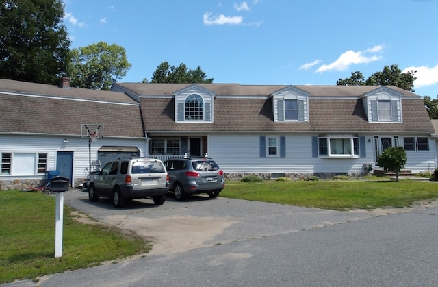 view of front of home with a garage and a front yard