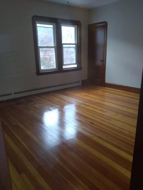 129 Marchand St, Fall River, MA 02723 - unfurnished room with a baseboard radiator, wood finished floors, and baseboards