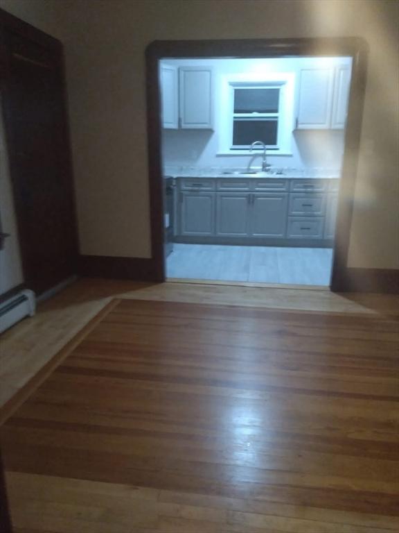129 Marchand St, Fall River, MA 02723 - kitchen featuring a sink, light wood-style floors, and light countertops