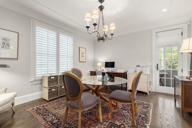 dining space with dark wood-type flooring, crown molding, baseboards, and a chandelier