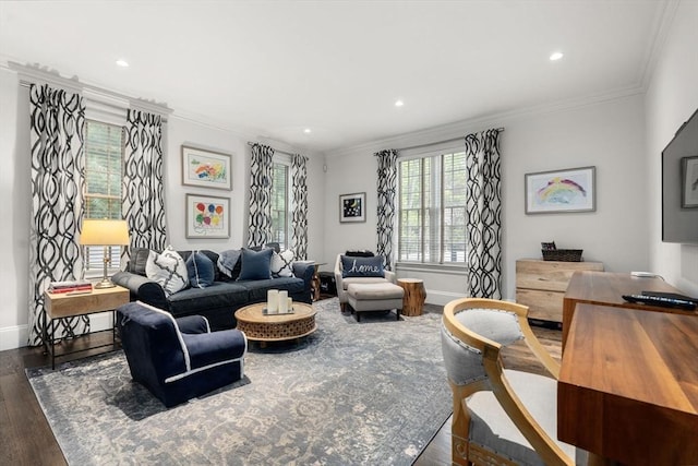 living area with wood finished floors, ornamental molding, baseboards, and recessed lighting