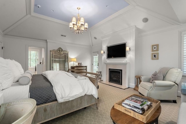 bedroom with a chandelier, a fireplace with raised hearth, carpet, lofted ceiling, and ornamental molding
