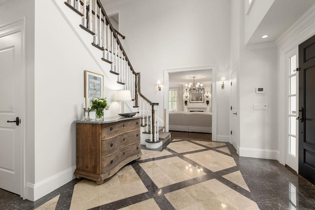 foyer entrance featuring inlaid floor details, baseboards, stairway, a chandelier, and recessed lighting