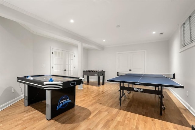 recreation room with light wood-style flooring, baseboards, recessed lighting, and ornamental molding
