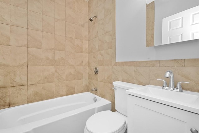 full bathroom with toilet, vanity, tile walls, and tiled shower / bath