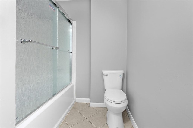 bathroom with tile patterned floors, toilet, and enclosed tub / shower combo