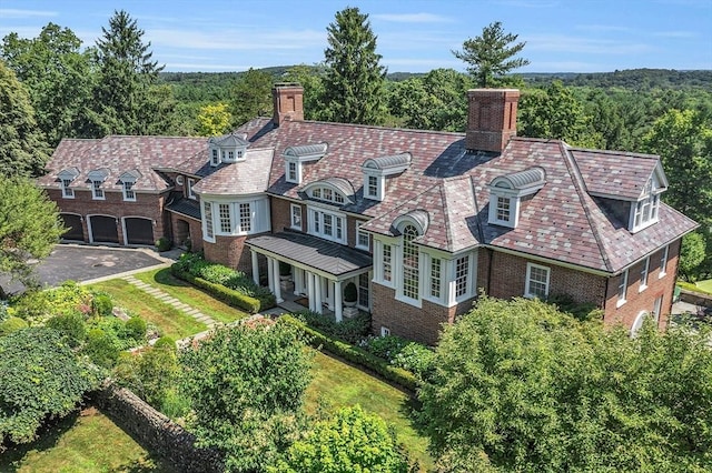 29 Willard Cmn, Concord, MA 01742 - view of front facade with a chimney, a high end roof, brick siding, and asphalt driveway