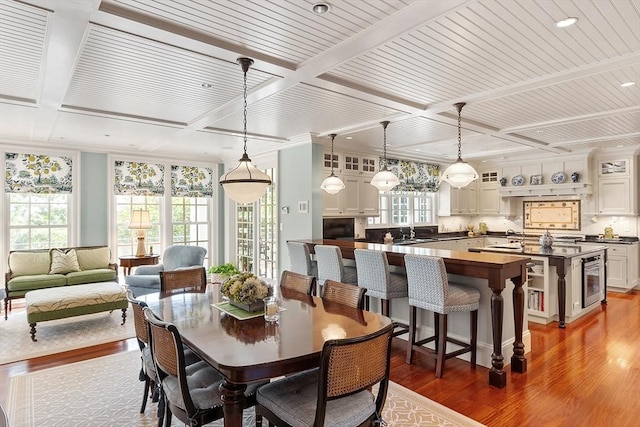 29 Willard Cmn, Concord, MA 01742 - dining area featuring coffered ceiling, wood finished floors, wine cooler, beamed ceiling, and recessed lighting