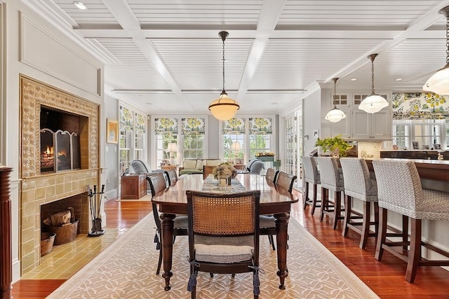 29 Willard Cmn, Concord, MA 01742 - dining space featuring beamed ceiling, wood finished floors, a fireplace, coffered ceiling, and crown molding