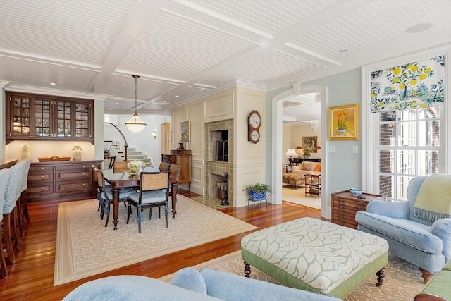 29 Willard Cmn, Concord, MA 01742 - dining area featuring arched walkways, stairway, wood finished floors, beamed ceiling, and coffered ceiling