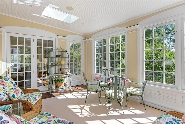 29 Willard Cmn, Concord, MA 01742 - sunroom featuring french doors, a skylight, vaulted ceiling, and plenty of natural light
