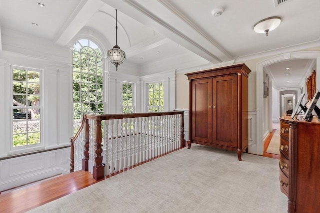 29 Willard Cmn, Concord, MA 01742 - hallway featuring a decorative wall, beam ceiling, plenty of natural light, ornamental molding, and a chandelier
