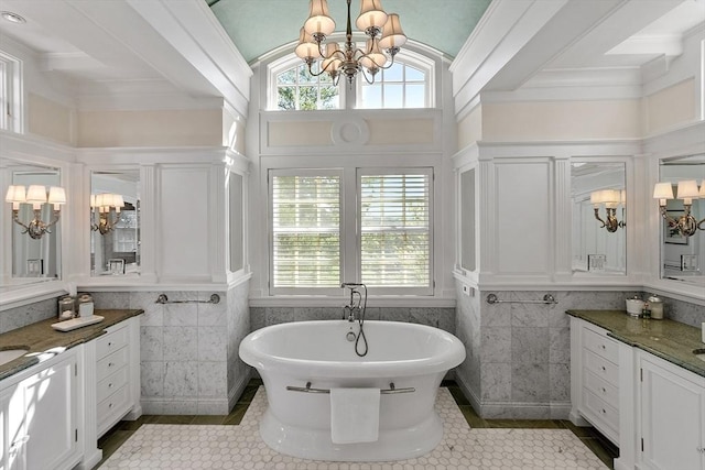 29 Willard Cmn, Concord, MA 01742 - bathroom featuring a chandelier, vanity, a freestanding bath, tile patterned floors, and tile walls