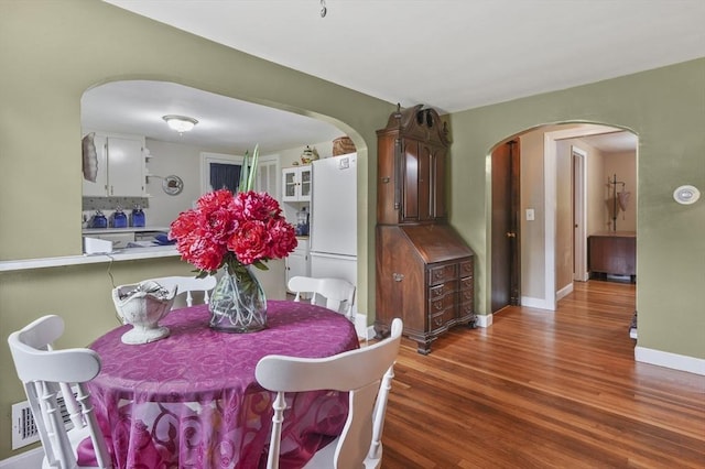 49 Winchendon Rd, Templeton, MA 01436 - dining space featuring arched walkways and wood finished floors