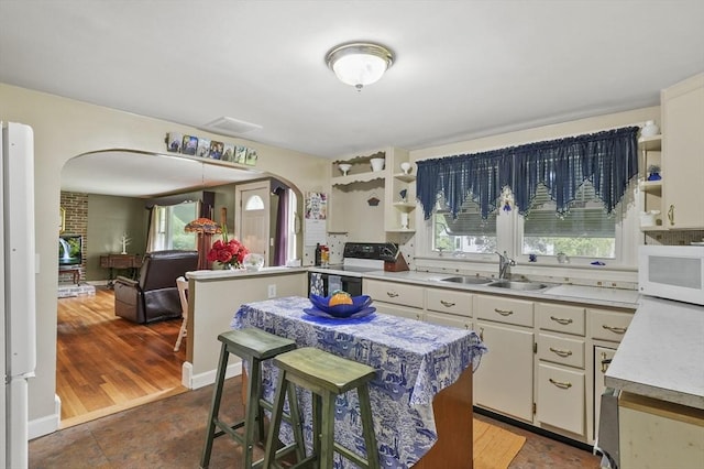 49 Winchendon Rd, Templeton, MA 01436 - kitchen with arched walkways, white appliances, open shelves, and light countertops