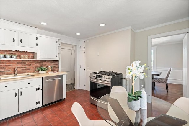 52 Myrtle St, Newton, MA 02465 - kitchen with stainless steel appliances, crown molding, light countertops, white cabinetry, and recessed lighting