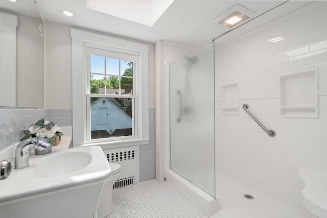 52 Myrtle St, Newton, MA 02465 - bathroom with radiator heating unit, a shower stall, tile patterned flooring, tile walls, and vanity