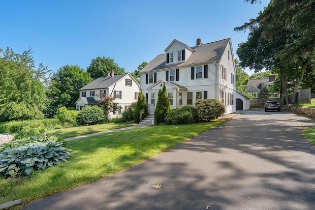 52 Myrtle St, Newton, MA 02465 - view of front of house with a front yard, a chimney, driveway, and a residential view