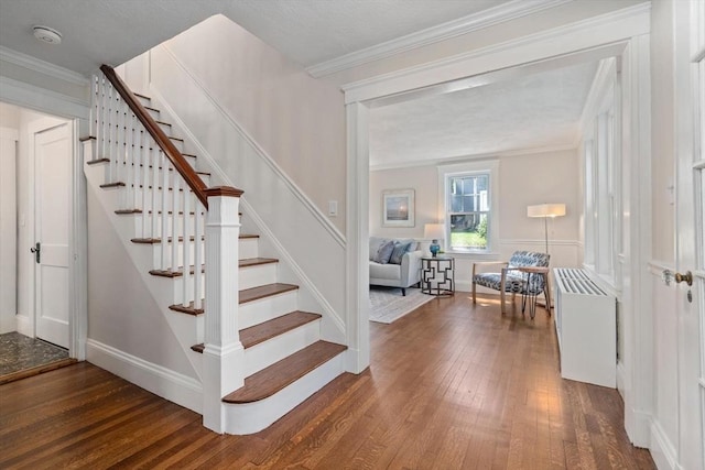 52 Myrtle St, Newton, MA 02465 - stairs featuring wood finished floors, crown molding, and radiator