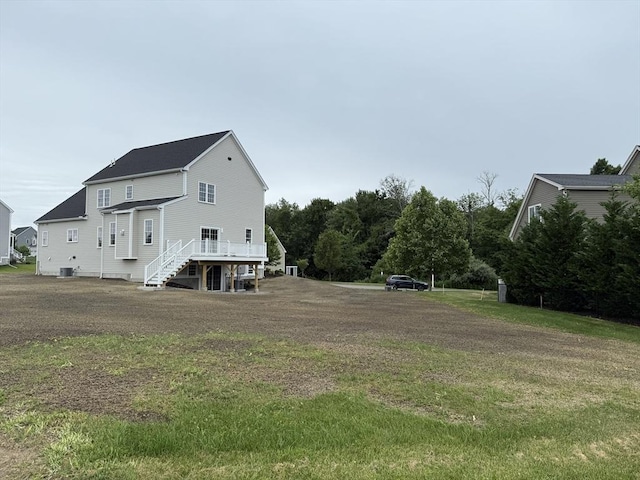 87 Magill Dr, Grafton, MA 01519 - back of house featuring stairway, a wooden deck, and a lawn