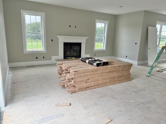 87 Magill Dr, Grafton, MA 01519 - unfurnished living room with plenty of natural light and a glass covered fireplace
