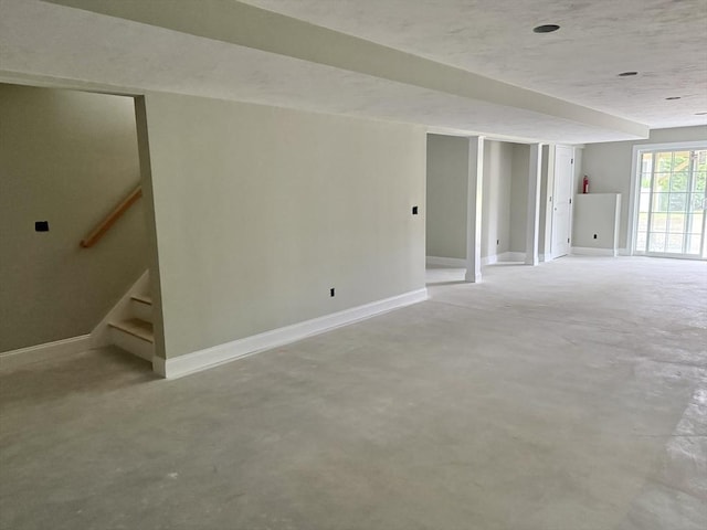 87 Magill Dr, Grafton, MA 01519 - unfurnished living room with concrete flooring and stairs