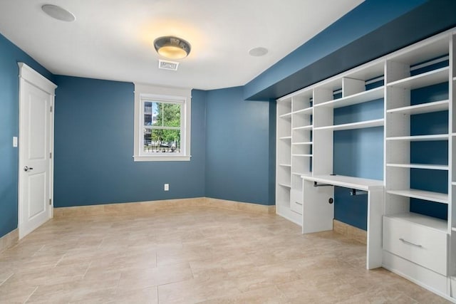 unfurnished bedroom with baseboards and visible vents