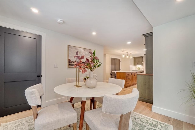 dining space with light hardwood / wood-style flooring