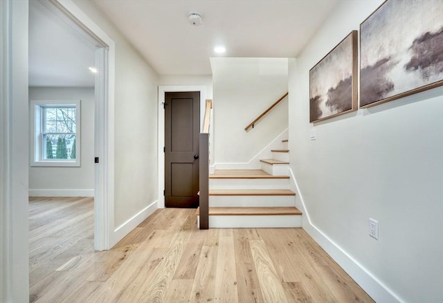 stairs with hardwood / wood-style floors