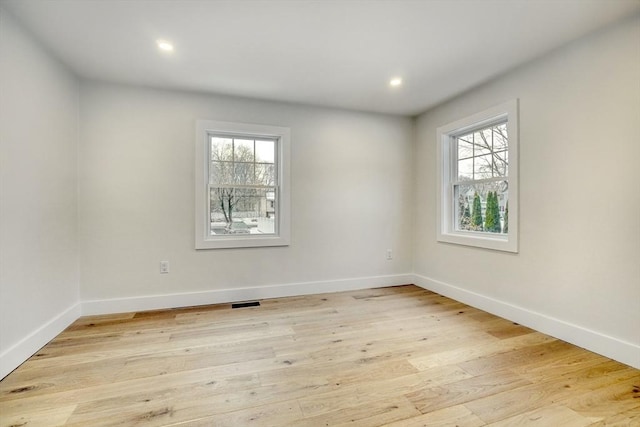 unfurnished room with plenty of natural light and light wood-type flooring