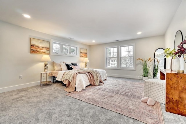 carpeted bedroom featuring multiple windows