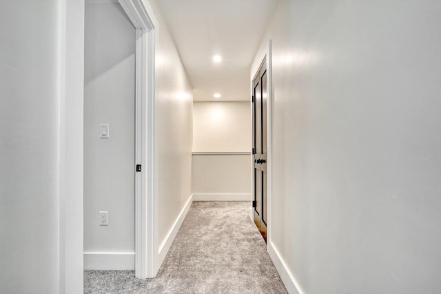 hallway with light colored carpet