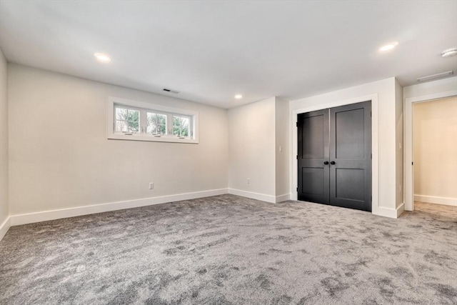 unfurnished bedroom featuring carpet floors and a closet