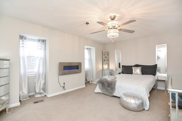 bedroom featuring carpet flooring, multiple windows, and ceiling fan