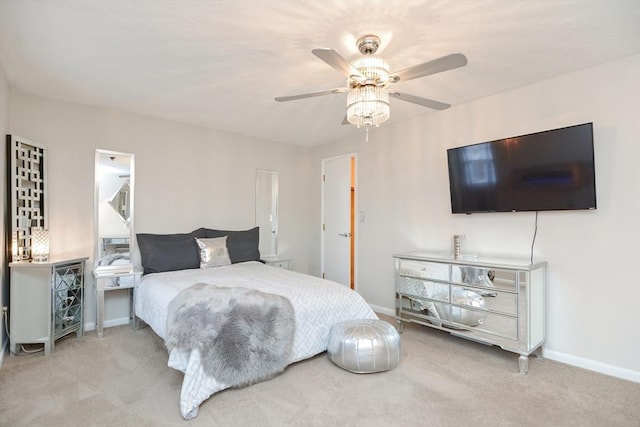 bedroom with ceiling fan and light carpet