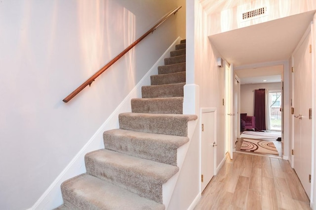 staircase featuring hardwood / wood-style flooring