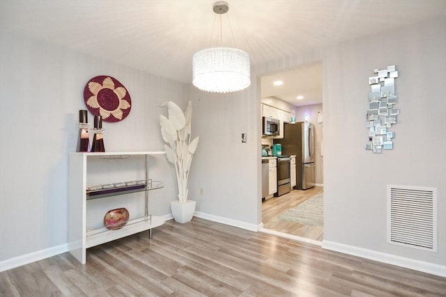 unfurnished dining area with light wood-type flooring