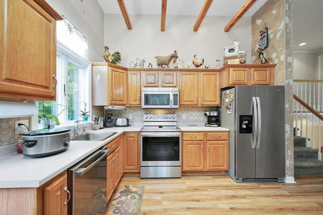 1 Fellowship Cir, Wareham, MA 02576 - kitchen featuring appliances with stainless steel finishes, a sink, light wood-type flooring, decorative backsplash, and beamed ceiling