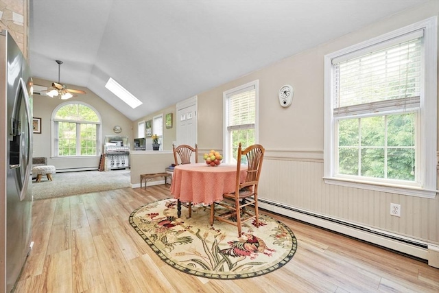 1 Fellowship Cir, Wareham, MA 02576 - dining area featuring wood finished floors, a baseboard radiator, vaulted ceiling, a skylight, and ceiling fan