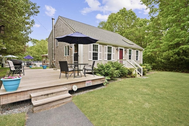 1 Fellowship Cir, Wareham, MA 02576 - back of property featuring a yard, roof with shingles, a wooden deck, and outdoor dining area