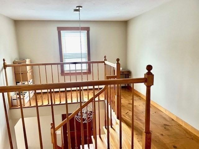 stairs featuring baseboards and wood finished floors