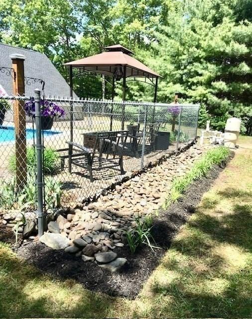 view of home's community featuring fence and a gazebo