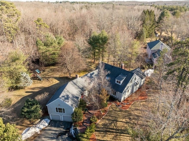 drone / aerial view with a wooded view