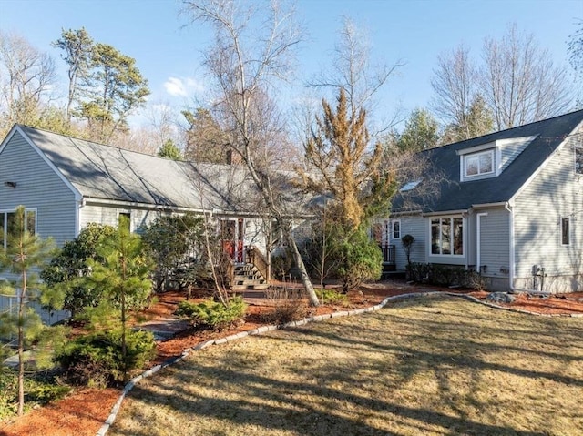 rear view of house featuring a yard