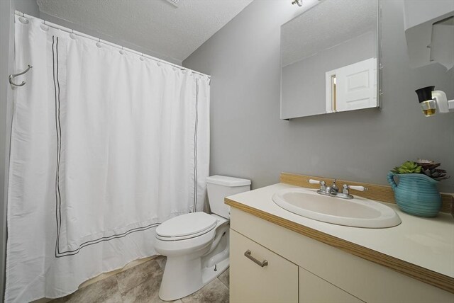 34 Newhall St Unit 313, Lowell, MA 01852 - bathroom featuring curtained shower, vanity, a textured ceiling, and toilet