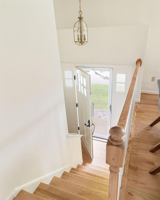 50 Hillside Rd, Tewksbury, MA 01876 - staircase with wood finished floors, a chandelier, and baseboards