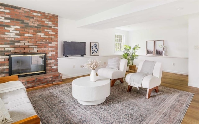 50 Hillside Rd, Tewksbury, MA 01876 - living area with wood finished floors, baseboards, and a brick fireplace