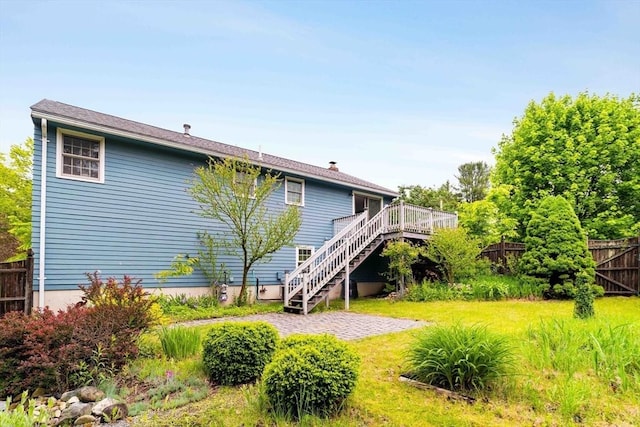 50 Hillside Rd, Tewksbury, MA 01876 - rear view of property with stairway, a wooden deck, and a chimney